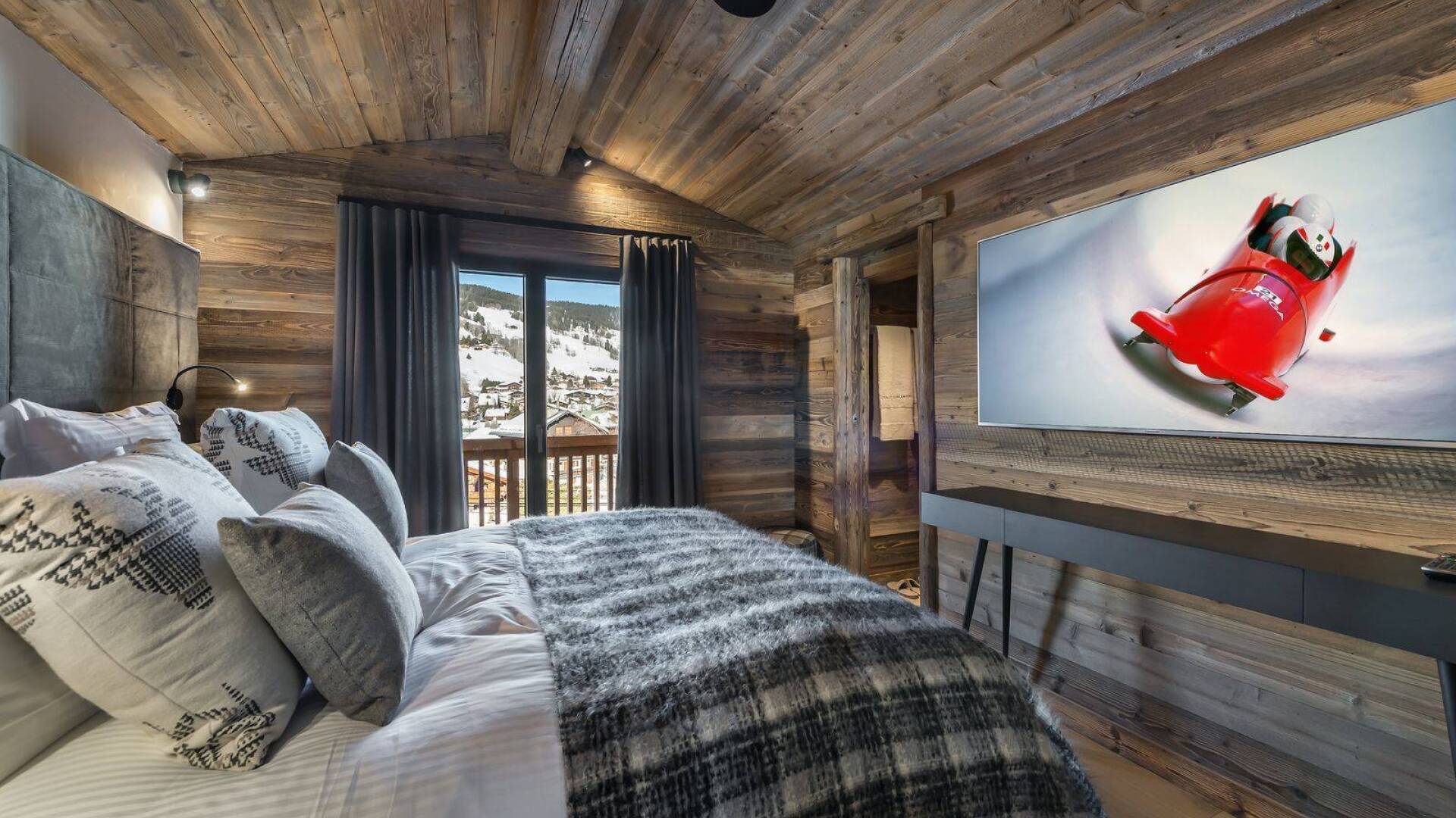 double bedroom with TV and access to balcony