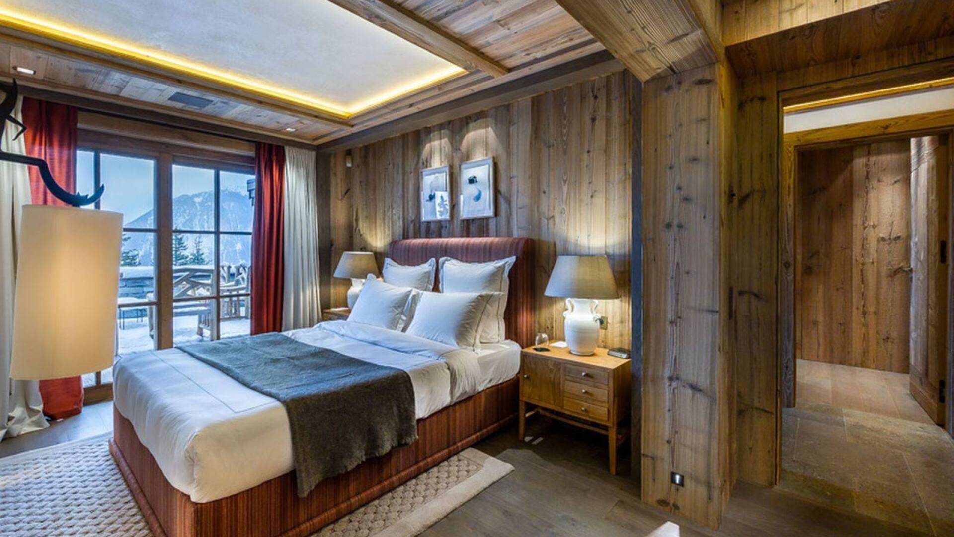 large double bedroom with balcony and sweeping views of Courchevel