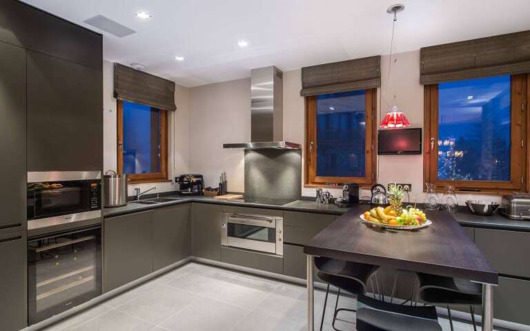 modern kitchen with cooking island and stools