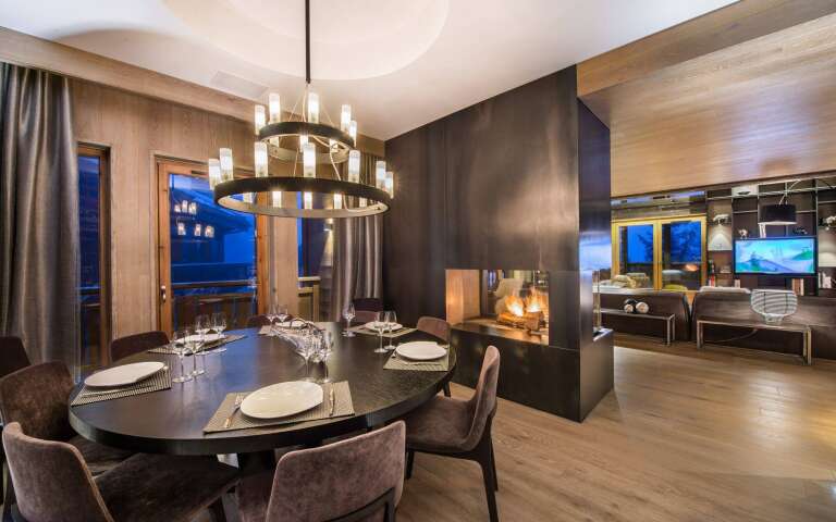 modern dining area with fireplace and TV