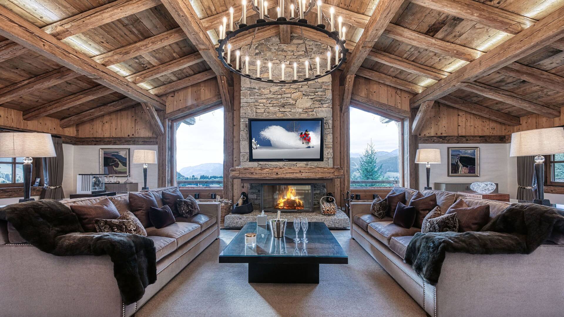 opulent living room with majestic French windows, fireplace and TV