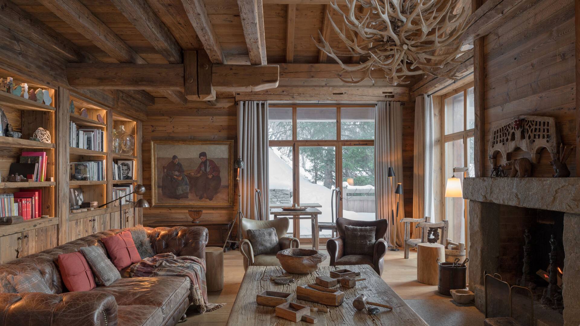 cosy living room with large windows and traditional fireplace