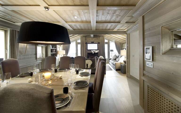 dining and living area with wooden table and fireplace