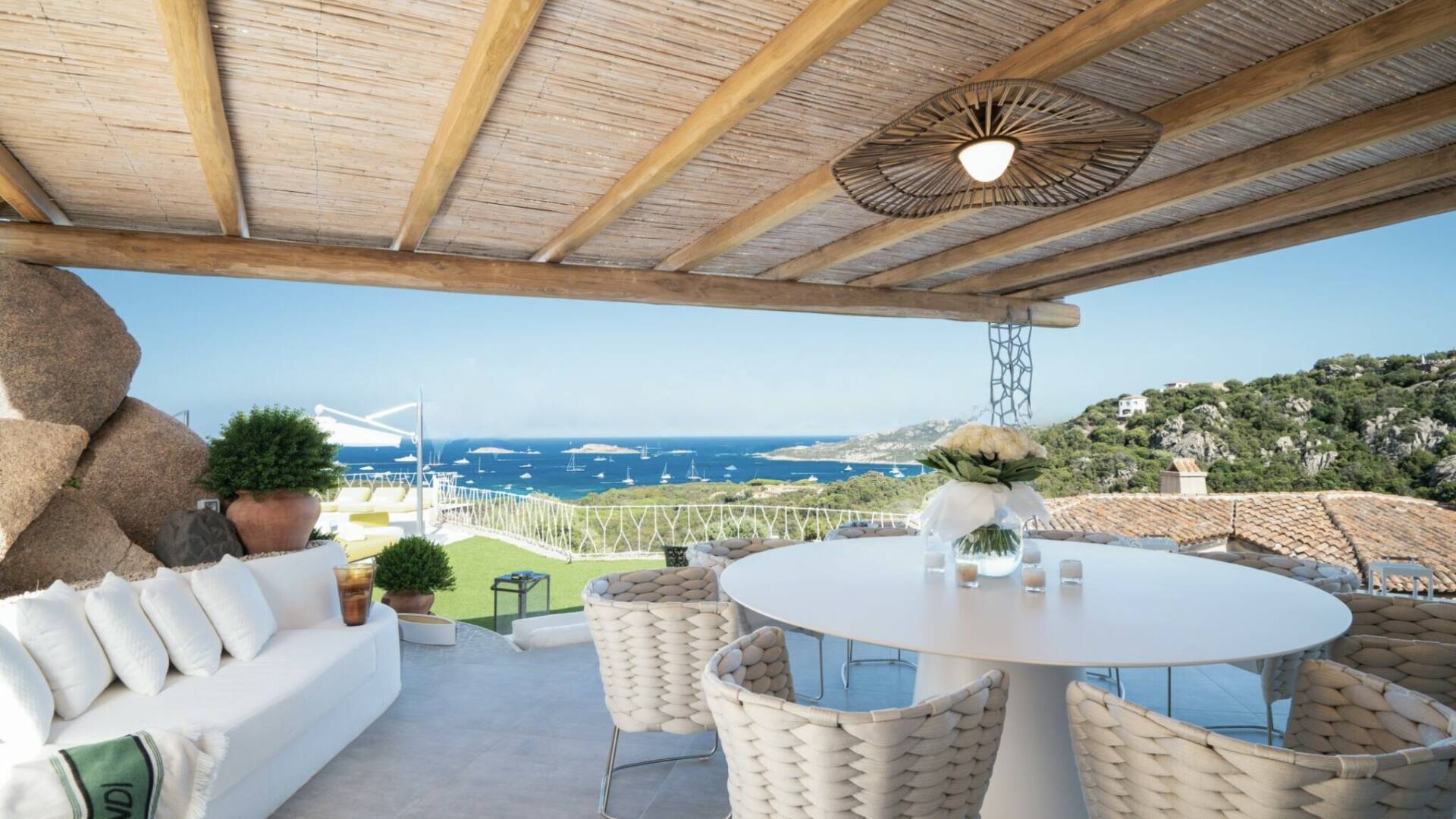 alfresco dining area with pool and sea view