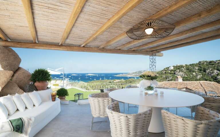 alfresco dining area with pool and sea view