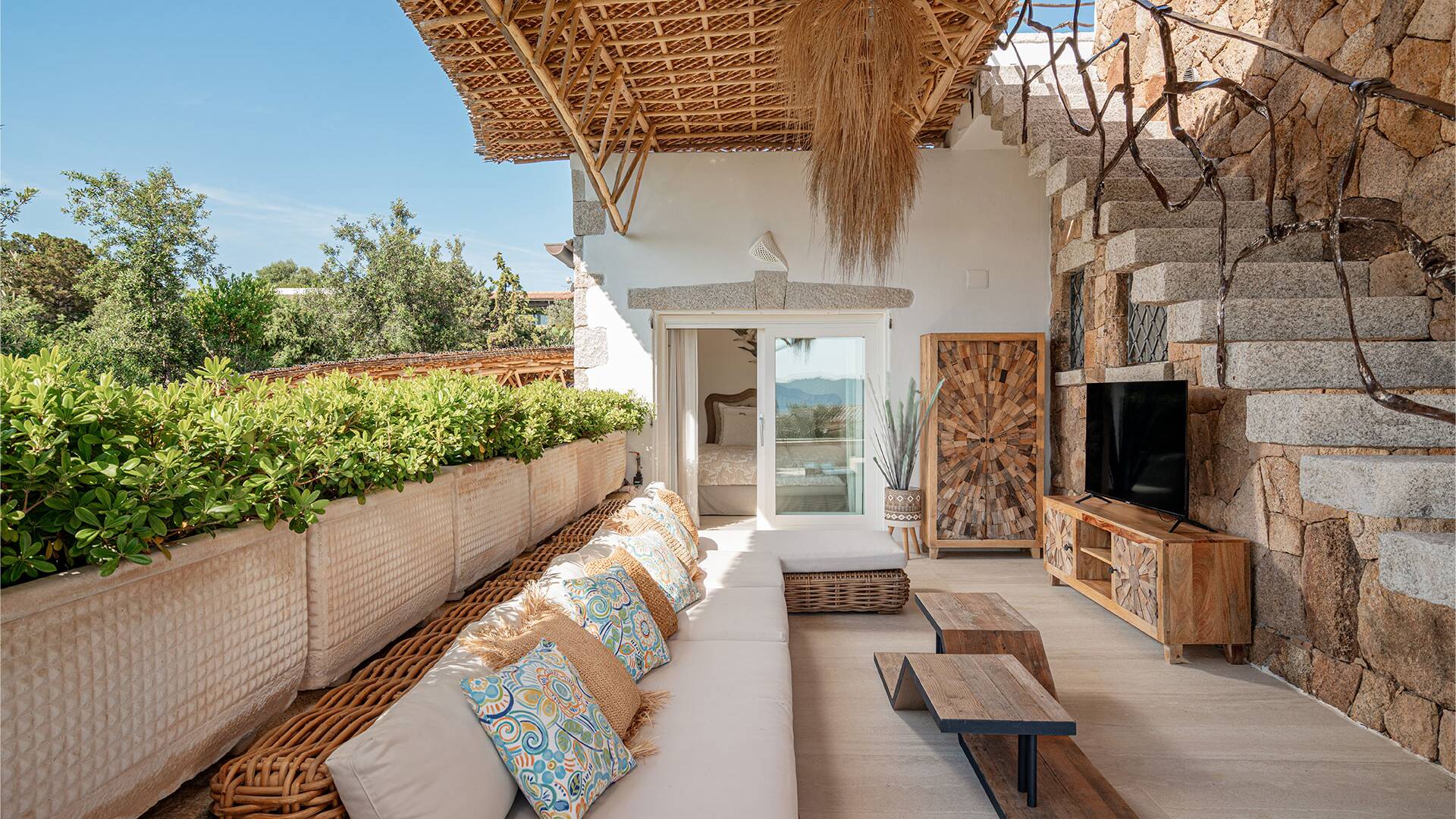 covered outdoor sitting area with TV