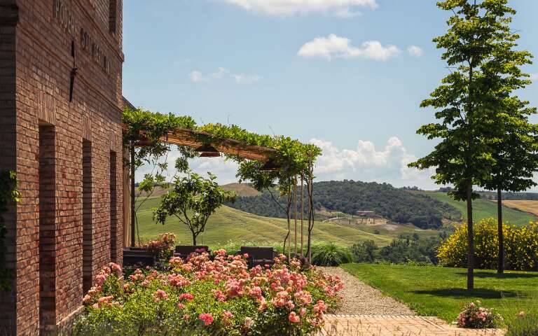 covered sitting area surrounded by Tuscan countryside