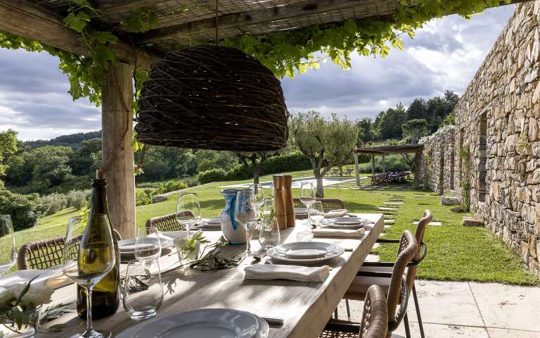 covered al fresco dining table by the private pool