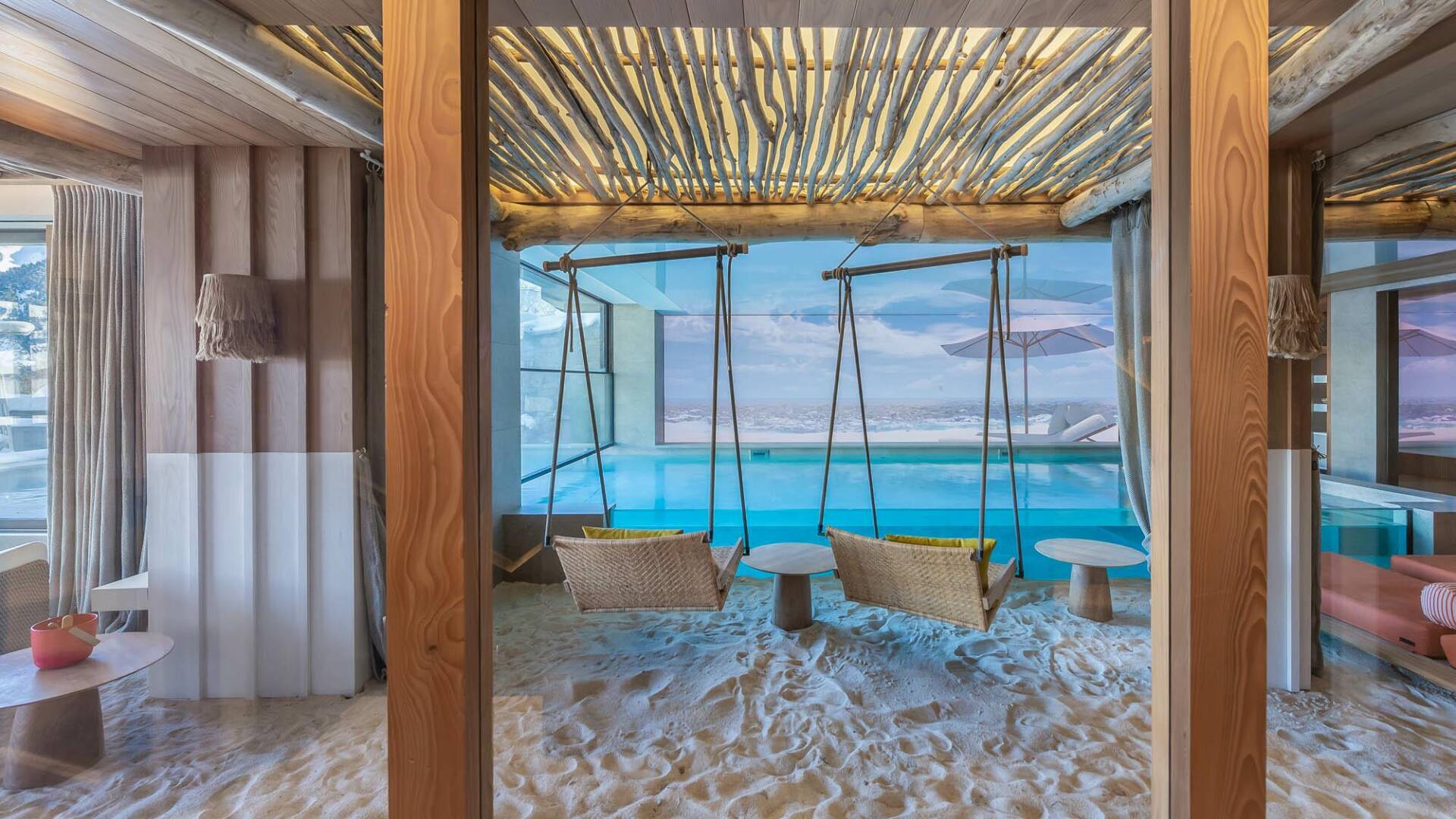 luxury indoor/outdoor heated pool with swings and white sand
