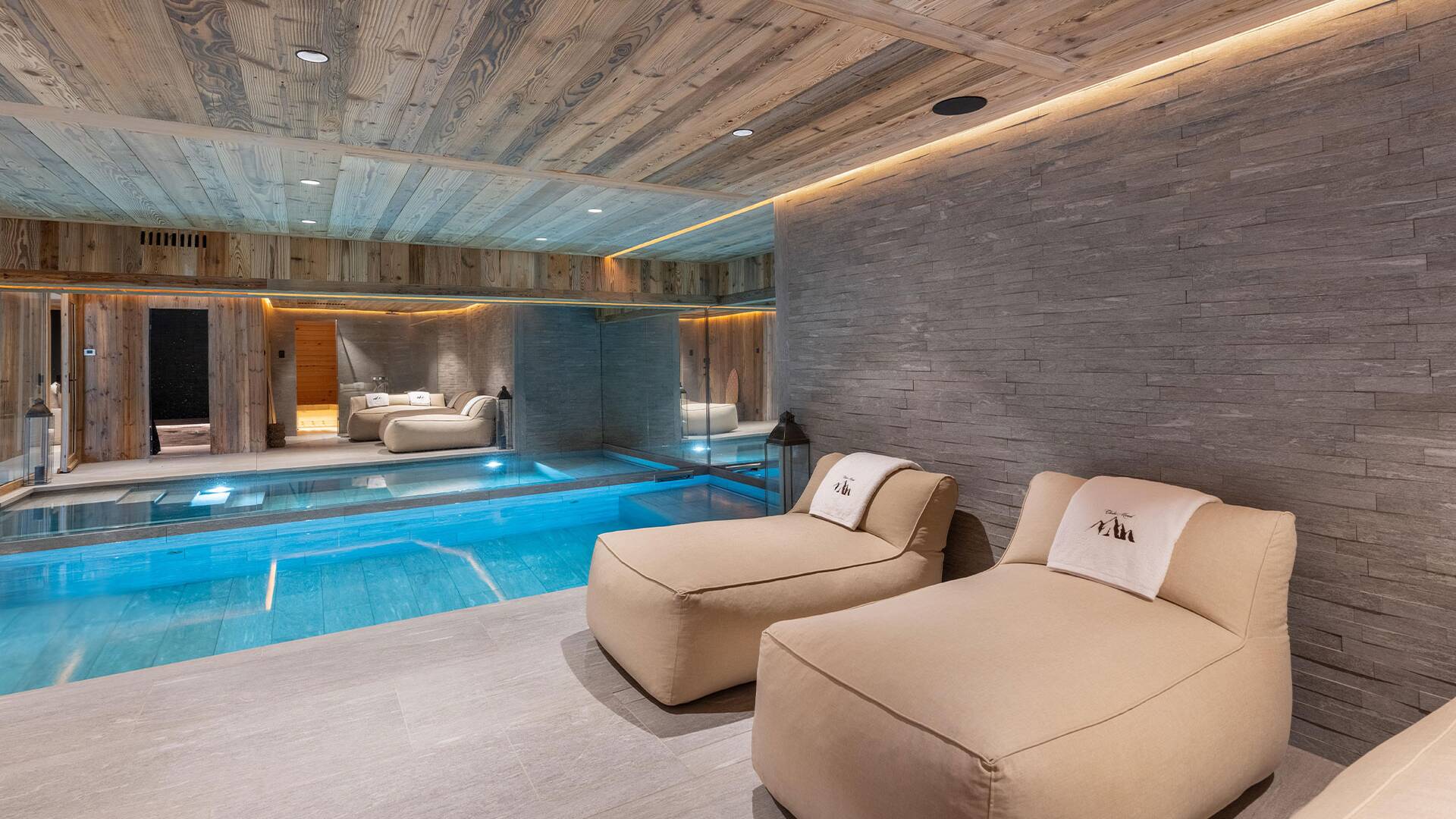 luxury indoor pool with cosy lounge area