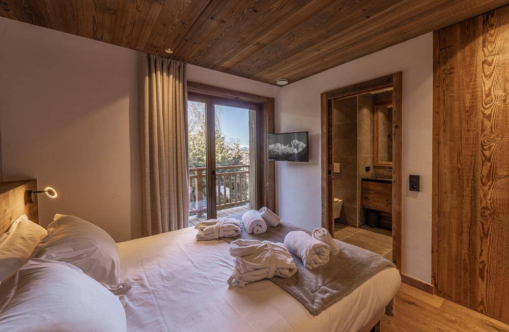 luxury double bedroom with access to balcony and en suite bathroom