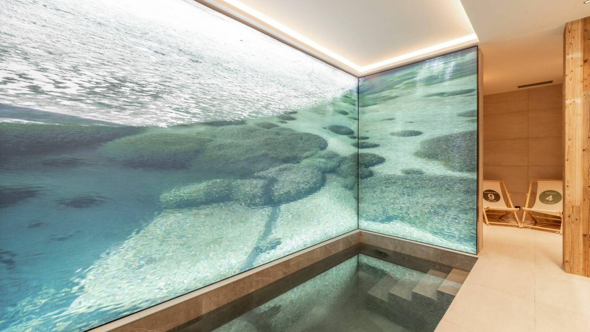 luxury indoor splash pool with decorated walls