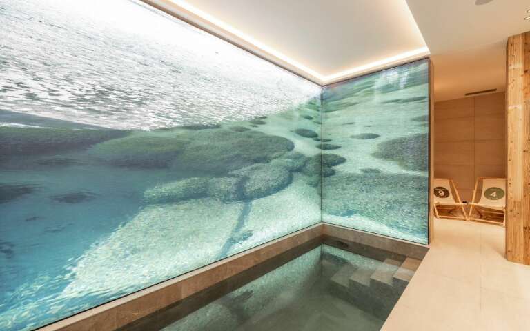 luxury indoor splash pool with decorated walls