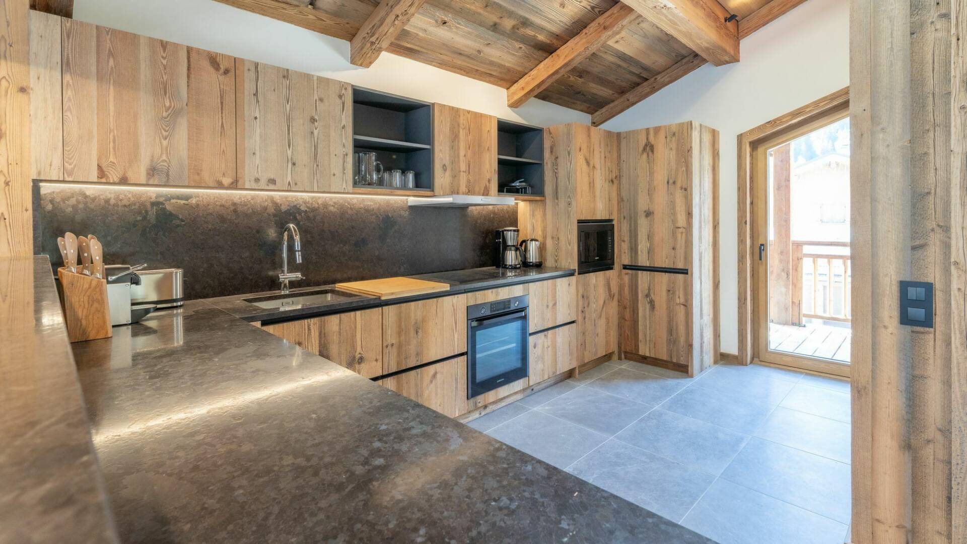 fully-equipped kitchen with access to outdoors
